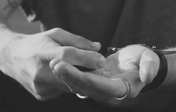 Close up of beard oil in the palm of a man's hand