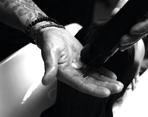 Hair being shampooed by hands