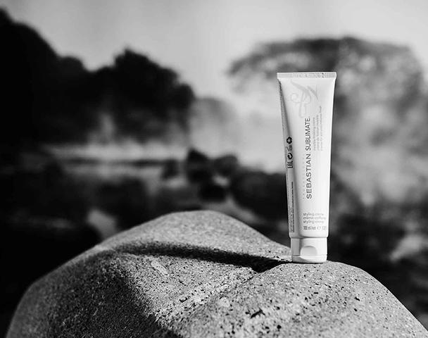 A white tube of Sublimate hair cream on a sunlit rock